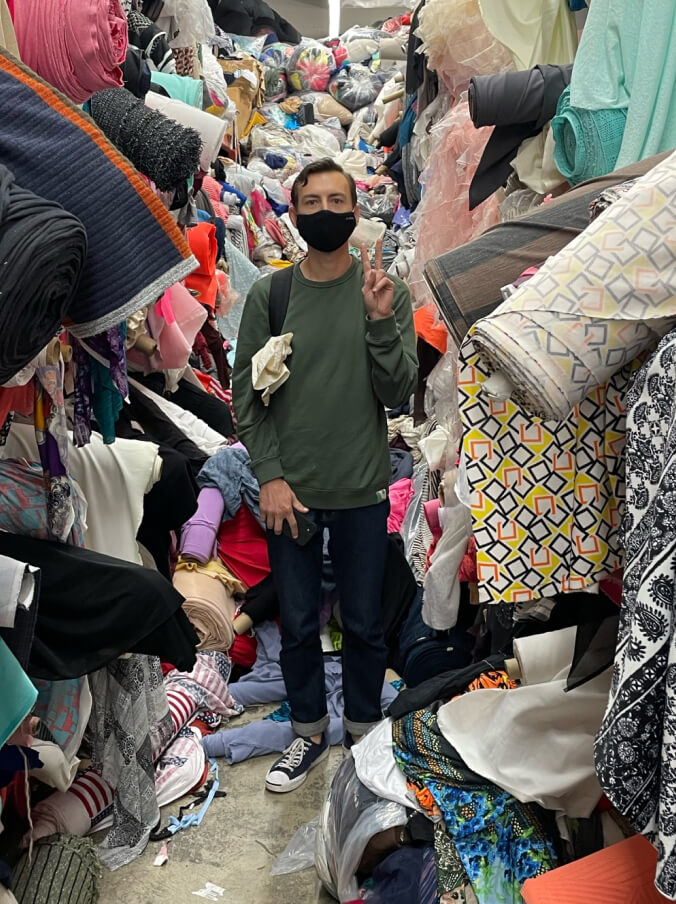 A man standing in a fabric shop